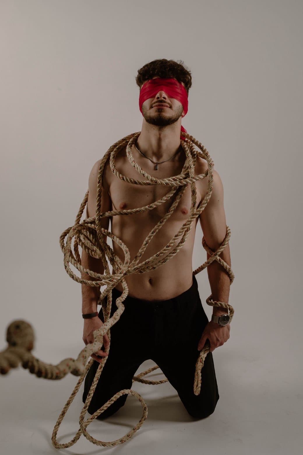 Bound editorial portrait with red blindfold