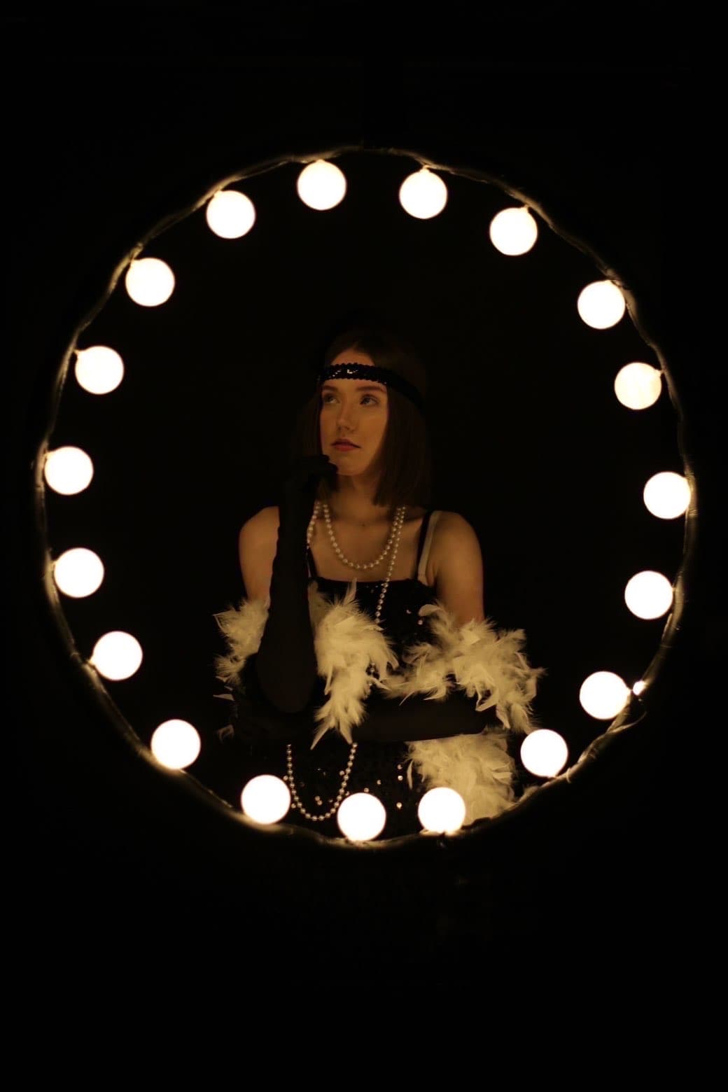 Circular ring-light portrait with floral styling