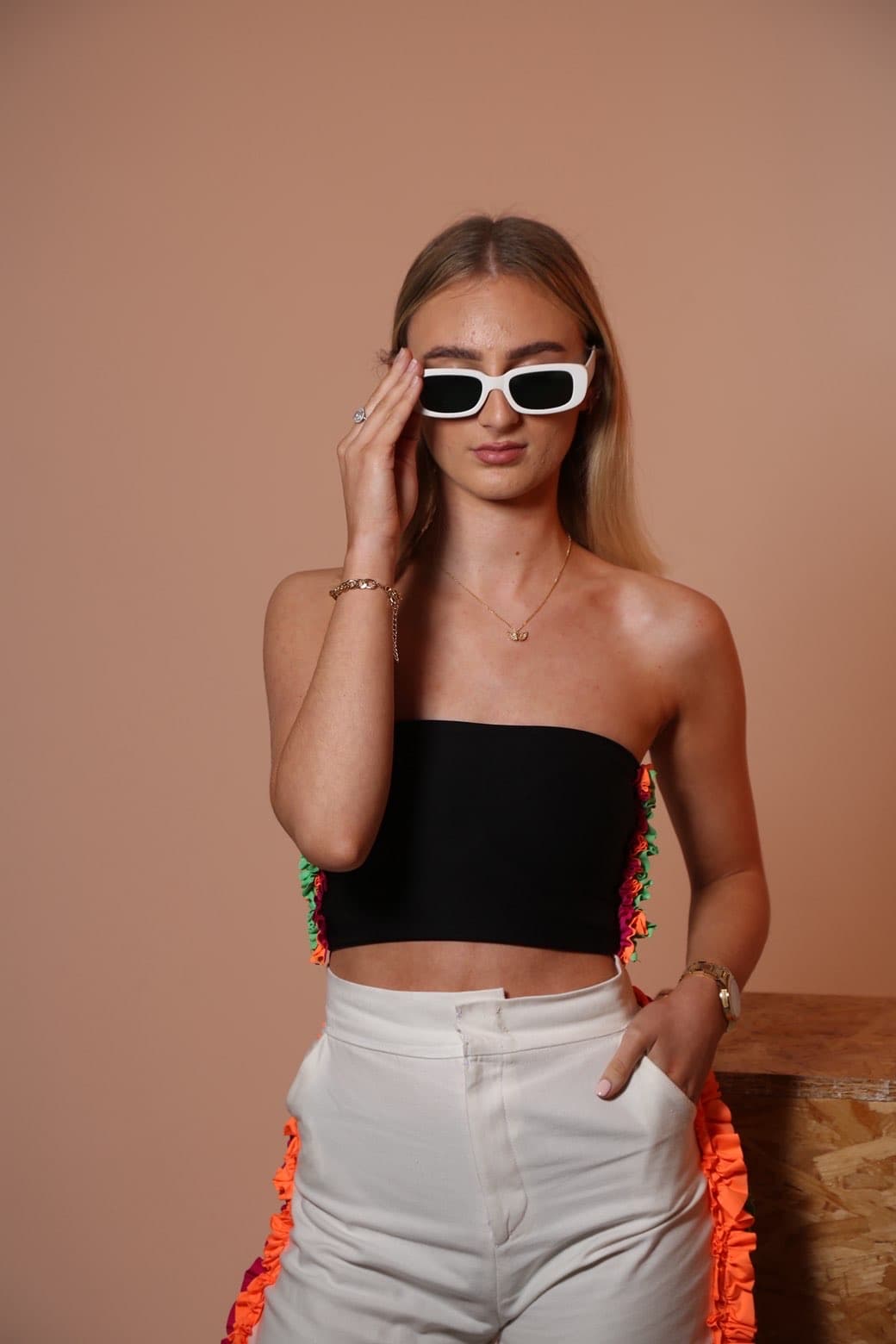 Standing studio fashion portrait with white sunglasses